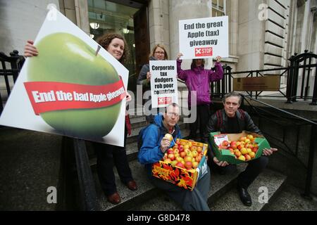 Members of the Debt & Development Coalition Ireland holding a protest outside Department of Finance in Dublin where they are calling for the Public Accounts Committee to investigate the tax rulings system, by which they say Revenue gives away billions in revenues to Apple and other multinational corporations. Stock Photo