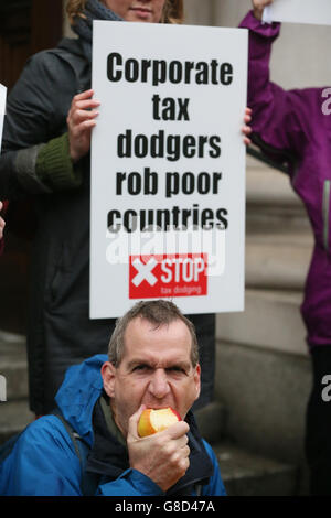 Members of the Debt & Development Coalition Ireland holding a protest outside Department of Finance in Dublin where they are calling for the Public Accounts Committee to investigate the tax rulings system, by which they say Revenue gives away billions in revenues to Apple and other multinational corporations. Stock Photo