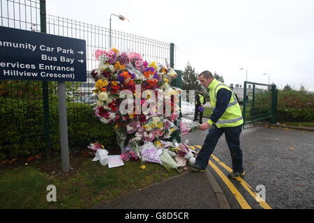 Floral tributes are left outside Cults Academy in Aberdeen, as police continue to question a teenager after a 16-year-old boy died in a stabbing at the secondary school. Stock Photo