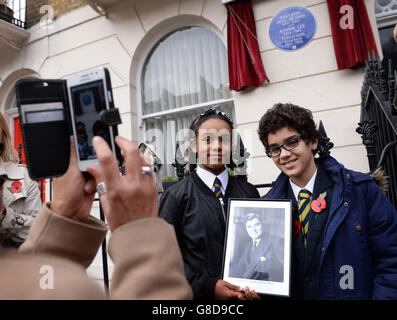 10-year-olds Amina Douglas (left) and Omar it el Caid, pupils at St Clement Danes School in London, pose for a photograph outside 23 Cliveden Place in Chelsea, the former home of Aneurin Bevan and Jennie Lee, after an English Heritage blue plaque was unveiled. Stock Photo
