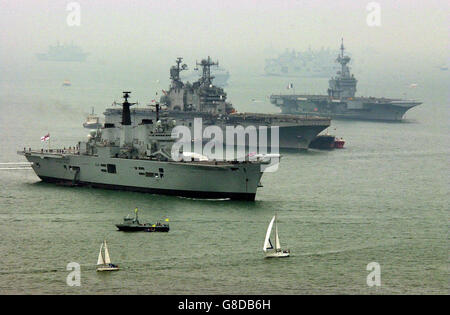 HMS Invincible (front) with the USS Saipan and the French aircraft carrier Charles de Gualle line up off Portsmouth as ships gather from around the world for the International Fleet Review which will be held off the coast of Portsmouth on the 28th June. Stock Photo