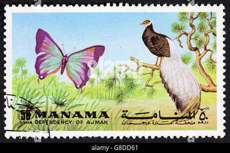 GROOTEBROEK ,THE NETHERLANDS - MARCH 15,2016 : A stamp printed in the Manama Ajman showing a butterfly and birds circa 1972. Stock Photo
