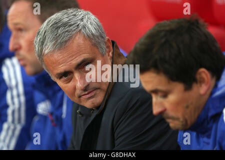 Soccer - Capital One Cup - Fourth Round - Stoke City v Chelsea - Britannia Stadium. Chelsea manager Jose Mourinho sat on the bench before the game Stock Photo