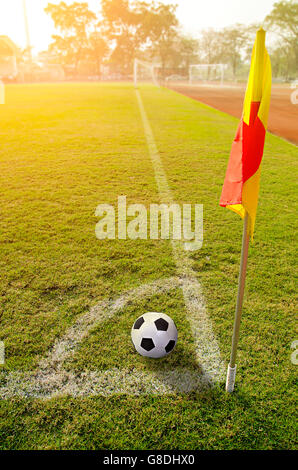 Corner flag with ball on a soccer field Stock Photo