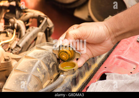 Man mechanic working repair engine and checking Radiator suitable for  background man working or background engine Stock Photo