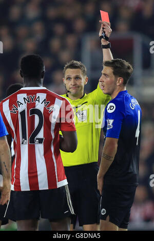 Referee Craig Pawson (centre) shows Southampton's Victor Wanyama a red card for a second bookable offence Stock Photo