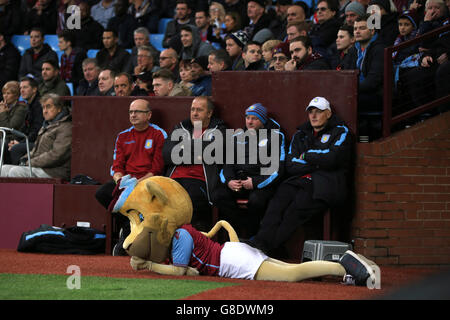 Aston Villa club mascot Bella the Lion watches the game from the sidelines during the Barclays Premier League match at Villa Park, Birmingham. Stock Photo