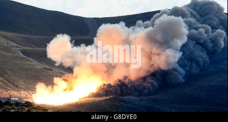 June 28, 2016. Promontory UT. Raw fire power is blasted into a hillside as ATK test fires a solid rocket booster motor that burns 6 tons of propellant each second with expanding gases and flames exiting the nozzle at speeds in excess of Mach 3 and temperatures reaching 3,700 degrees Fahrenheit Tuesday. Orbital ATK test fire happen at 9:05am MT time and NASA will use measurements from more than 530 data channels to evaluate motor performance, acoustics, motor vibrations, nozzle modifications, insulation upgrades. Photo by Gene Blevins/LA DailyNews/ZumaPress. (Credit Image: © Gene Blevins via Stock Photo