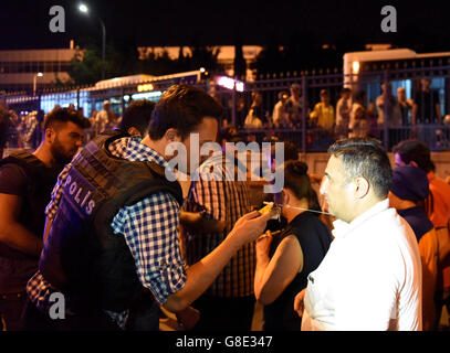 Istanbul, Turkey. 29th June, 2016. Policemen check staff licenses at the entrance to Ataturk International Airport in Istanbul, Turkey, June 29, 2016. Turkish Prime Minister Binali Yildirim on Wednesday blamed the Islamic State for the bombing attacks that killed 36 people at the airport Tuesday night. Credit:  He Canling/Xinhua/Alamy Live News Stock Photo