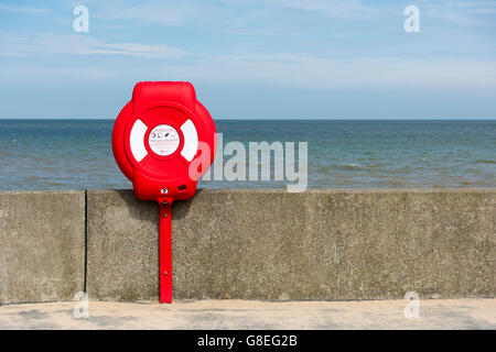 A lifebouy on the sea wall at Walton on the Naze by the north sea coast in the UK Stock Photo