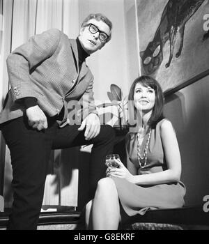 Michael Caine and Anjanette Comer in a London restaurant. Production starts tomorrow on Funeral in Berlin, the screen version of Len Deighton's sequel to The Ipcress File. Caine will be reprising the role of Harry Palmer. Stock Photo