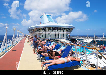 Passengers relaxing on board the cruise ship Discovery that belongs to the Thomson group. Stock Photo