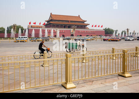 Beijing, China - Jun 20, 2016 : Scene of the Tiananmen square with cars, bicycles and the iconic golden colored fences. Stock Photo