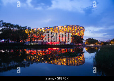 Beijing, China - Jun 21, 2016 : Night view of the National stadium with its reflection at the Beijing Olympic Park. Stock Photo