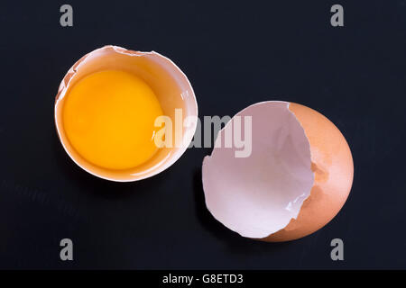 Cracked chicken egg on a black background Stock Photo