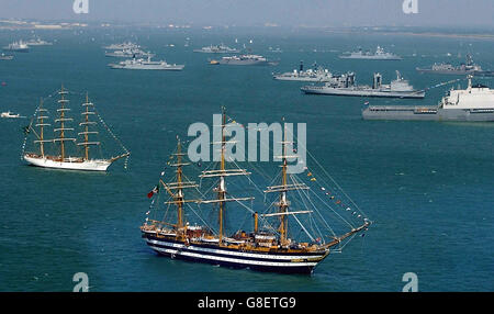 The scene in the Solent with Italian three mast full rigged sailing ship Amerigo Vespucci in foreground, where ships have anchored at Spithead, off Portsmouth, for the International Fleet Review which will be carried out by Britain's Queen Elizabeth II from HMS Endurance. As well as warships from navies around the world, the gathered vessels include tall ships, lifeboats, cruise liners and representatives from all sectors of the maritime industry. Stock Photo