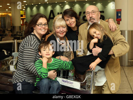 British film-maker Becky Prosser (centre), who was jailed in Indonesia for violating immigration laws, poses for a photo with her mother Carmel, father Bernard, sister Natalie (left)nephew Patrick Hendry and niece Leila as she arrives at Heathrow Airport. Stock Photo