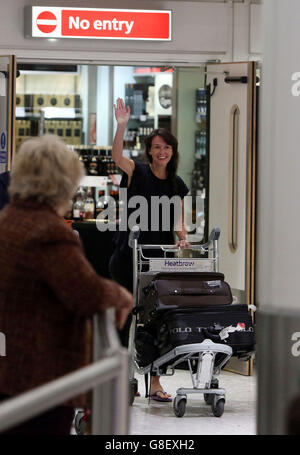 British film-maker Becky Prosser, 31, who was jailed in Indonesia for violating immigration laws, waves as she arrives at Heathrow Airport. Stock Photo