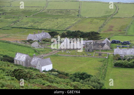 View across to Ruins of St Marys Abbey Tower and the graveyard on Bardsey Island, North Wales Stock Photo