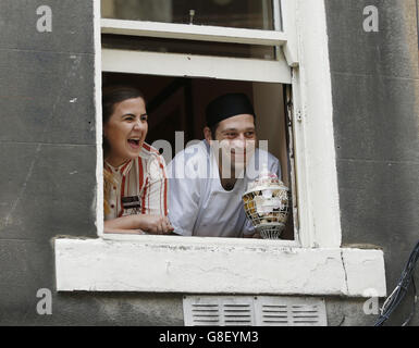 Fans wait for George Clooney in a window in Edinburgh, as he visits Social Bite, a cafe which helps the homeless. Stock Photo