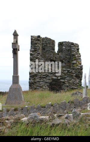 Celtic cross and Ruins of St Marys Abbey Tower at the graveyard on Bardsey Island, North Wales Stock Photo