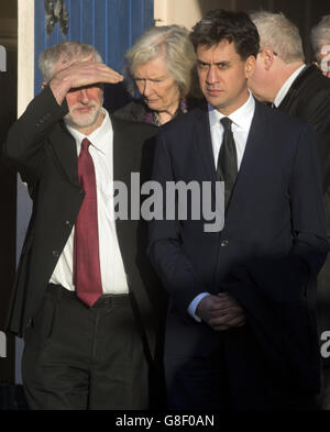 Labour leader Jeremy Corbyn (left) and his predecessor Ed Miliband leave after attending the funeral of former Labour MP Michael Meacher at St Mary's Church in Wimbledon, London. Stock Photo