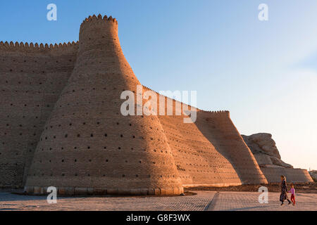 Mother and daughter walking by the city walls of Bukhara in Uzbekistan. Stock Photo