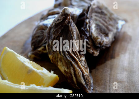 Wet Oysters with Fresh Lemon on the Side Stock Photo
