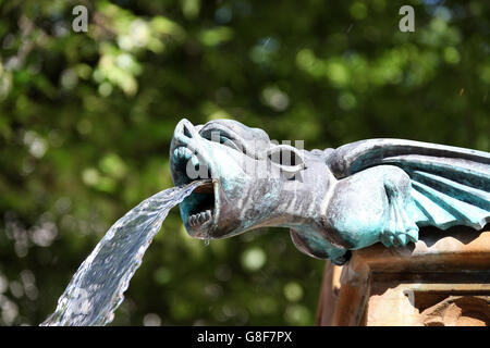 Gargoyle spouting water on the Queen Victoria Jubilee Fountain in Manchester Stock Photo