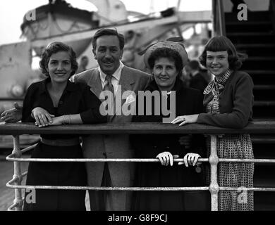 Accompanied by his wife and daughters - Diane, 16 and Sharon, 13 - Hollywood film producer Walt Disney arrives at Southampton aboard the Cunard- White Star liner 'Queen Elizabeth'. Disney has come to Britain to film 'Treasure Island'. Stock Photo