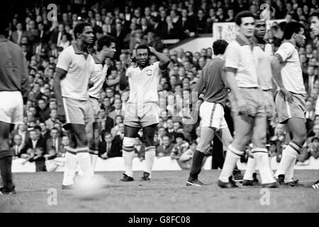 Soccer - World Cup England 1966 - Group Three - Portugal v Brazil - Goodison Park. Brazil's Pele (c) looks wearily at the Portugal defence after being on the receiving end of another nasty foul Stock Photo