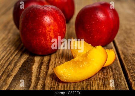 Fresh nectarine with water drops on wood table Stock Photo
