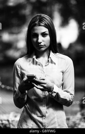 Portrait Of A Busy Sales Woman In Office And Using Her Cellphone - Businesswoman Working Online Stock Photo