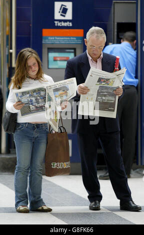 Commuters study the morning papers at London's Liverpool Street station . Scotland Yard have confirmed that at least 37 people died in Thursday's terror attacks on the capital, and said there were 700 casualties, 300 of whom were taken to hospital by ambulance, but a police source said the toll was likely to rise to at least 41 dead. Stock Photo