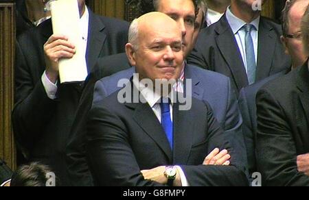 Work and Pensions Secretary Iain Duncan Smith listens to the Chancellor of the Exchequer, George Osborne deliver his joint Autumn Statement and Spending Review to MPs in the House of Commons, London. Stock Photo