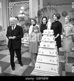 Charlie Chaplin is given a pre-birthday party on the set of his film A Countess from Hong Kong at Pinewood Studios. He will be 77 tomorrow. Behind him is his wife Oona, their children, and the stars of the film Sophia Loren and Tippi Hedren. Stock Photo