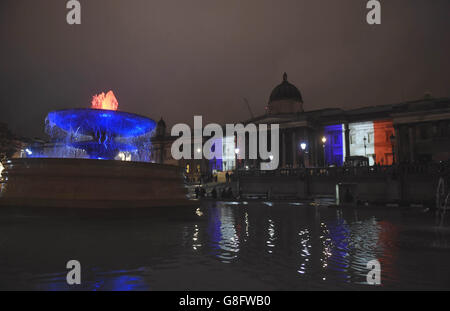 The National Gallery and Trafalgar Square Fountains, in London, illuminated with the colours of the French tricolor as London stands in solidarity with its sister European capital in the wake of a series of coordinated terrorist attacks in Paris on Friday night, which left at least 127 people dead and over 200 injured. Stock Photo