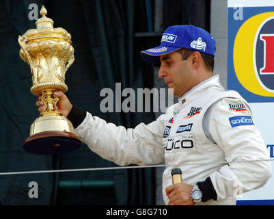 Colombia's and McLaren Mercedes driver Juan Pablo Montoya celebrates on the podium after winning the British Grand Prix. Stock Photo