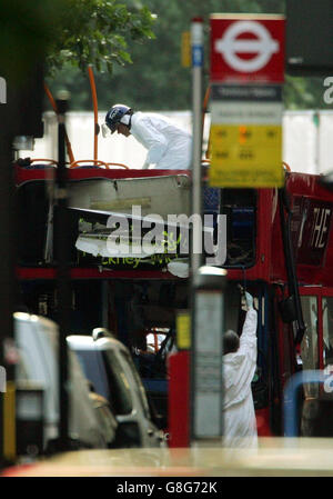 A police officer stands on what remains of the top deck of the number 30 bus, which was blown up by a bomb in the series of terrorist attacks in central London last Thursday morning. Stock Photo