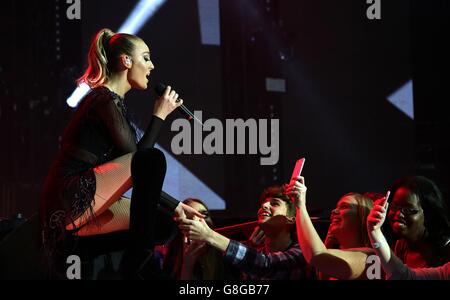 Perrie Edwards of Little Mix performs on stage during the Capital FM Jingle Bell Ball 2015 held at The O2 Arena, London Stock Photo