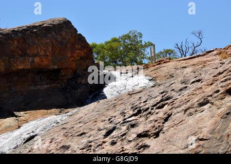 Serpentine falls with trickling water over the granite cliff under a clear blue sky in Serpentine, Western Australia Stock Photo