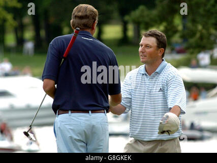 Golf - Barclays Scottish Open 2005 - Loch Lomond. South Africa's Tim Clark consoles second-placed dutchman Maarten Lafeber on the eighteenth green after winning. Stock Photo