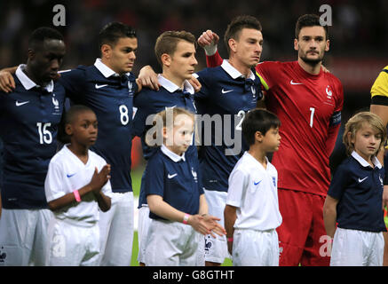 England v France - International Friendly - Wembley Stadium. France's Laurent Koscielny and Hugo Lloris during a minutes silence held for the victims of the Paris Terror Attack. Stock Photo