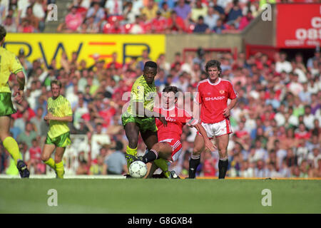 (l-r) Darren Beckford, Norwich City, overcomes the sliding tackle from Manchester United's Bryan Robson. Stock Photo