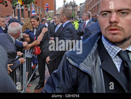 BNP Leader Nick Griffin (left), is hugged as he leaves court. Griffin pleaded not guilty to four race hate charges arising out of an undercover documentary about the party. Griffin appeared alongside party activist Mark Collett, who denies eight similar charges. Both men were charged following a police investigation stemming from the broadcast of the BBC Secret Agent programme. Stock Photo