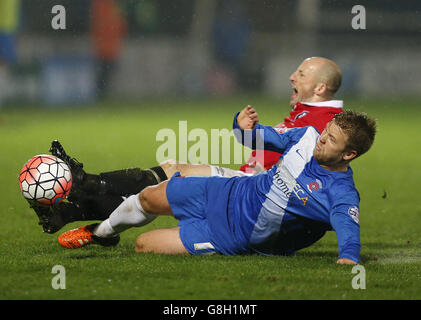 Hartlepool United's Nicky Featherstone and Salford City's Christopher Lynch (top) battle for the ball during the Emirates FA Cup, second round replay match at Victoria Park, Hartlepool.