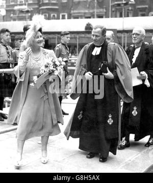 Queen Elizabeth, the Queen Consort, with Dr RFV Scott, Minister at St Columba's Church of Scotland since 1941, on the site of the new church in Pont Street, where she was laying the foundation stone. The new church to rise on this site replaces the original at St Columba's, principal place of worship for Scots in London, which was destroyed in the blitz of May 1941. Stock Photo