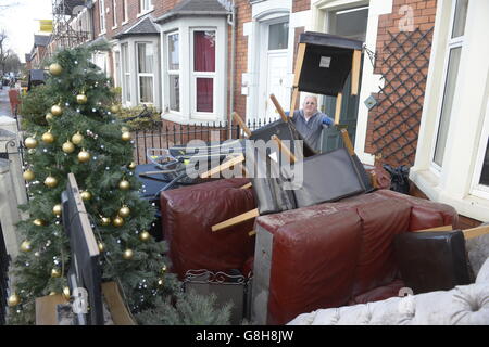 Residents pile up furniture, a television and a Christmas tree in the front garden of a house on Warwick Road in Carlisle as the clean-up begins after the floods. Stock Photo