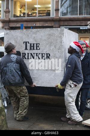 AK 47 (left) returns Banksy's sculpture 'The Drinker' as 'The Stinker' to Shaftesbury Avenue in London 'with some notable amendments' a decade after being removed. Stock Photo