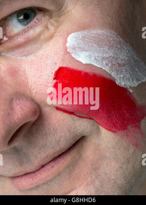 Closeup of young Polish supporter face painted with national flag colors Stock Photo